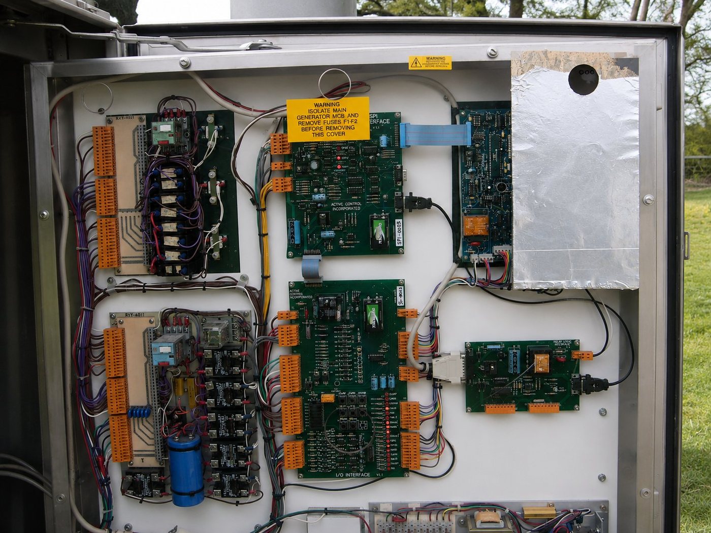 Interior of a Carter turbine control cabinet showing the Active Control boards, I/O interface, relay logic board, terminal blocks and field wiring