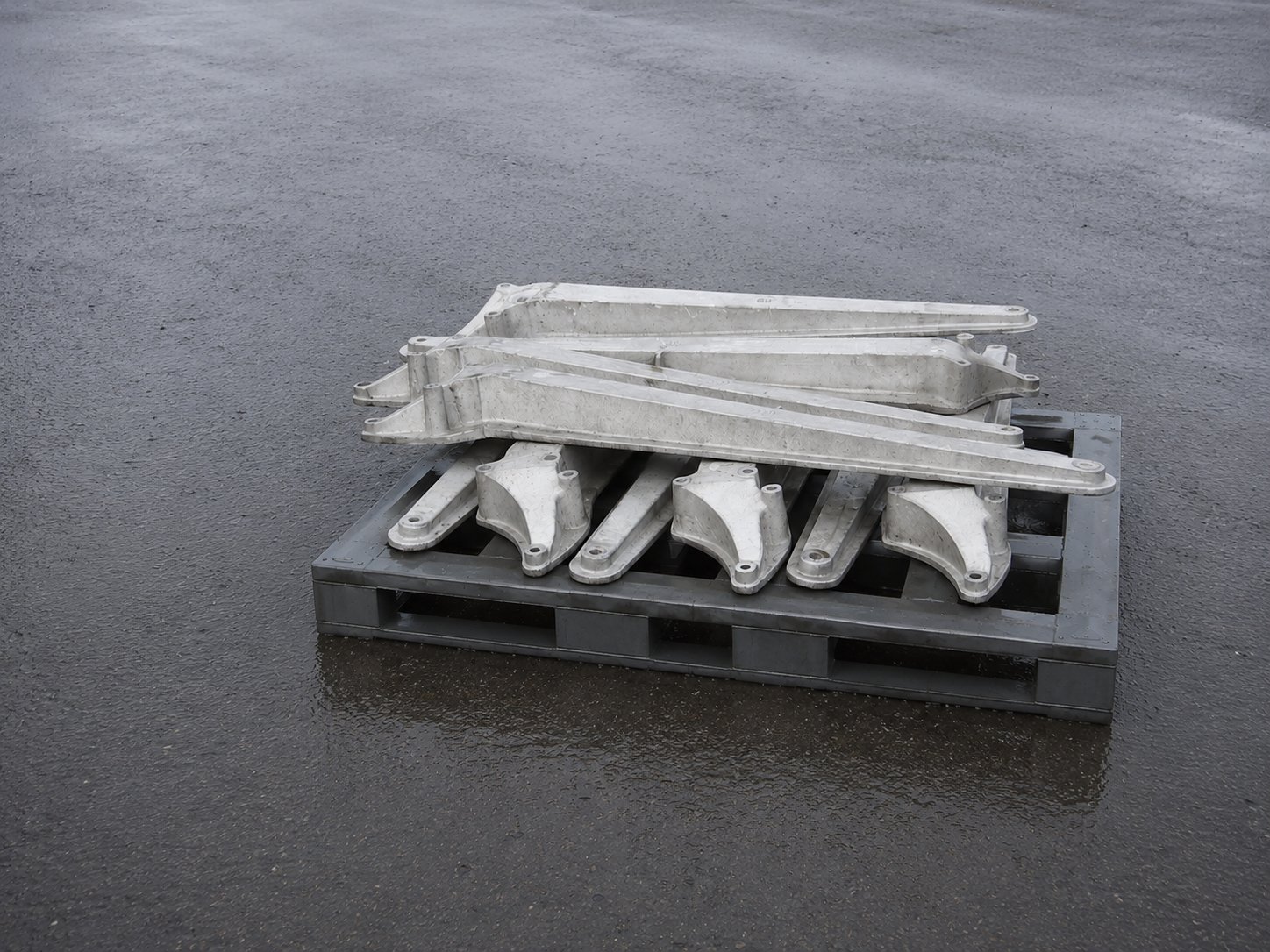 A pallet of cast aluminium blade counter-balance arms and root fittings in the factory yard
