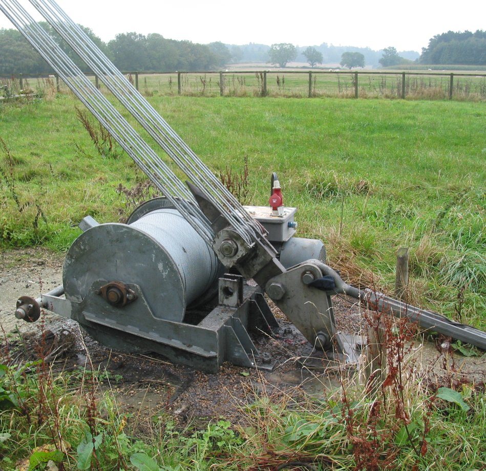 The Orton ground winch and drum on its pad, cables running to the tower