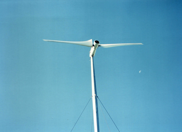 On load at Great Orton — the downwind teetered rotor coning gently under power on the guyed tower.