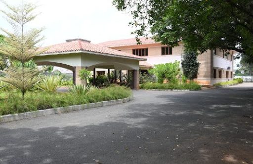 Joint venture offices in India — a low-rise building set among landscaped gardens and palms